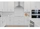 Well-lit kitchen with white cabinetry, stainless steel appliances, and ample counter space at 4017 W Fig St, Tampa, FL 33609