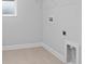 Compact laundry room with tiled floor, utility connections, and a small window at 4017 W Fig St, Tampa, FL 33609
