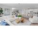 Spacious living room with a white sofa, kitchen island, and open floor plan at 4017 W Fig St, Tampa, FL 33609