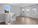 Bright living room features wood floors, large windows, and a glass door, providing ample natural light at 4017 W Fig St, Tampa, FL 33609