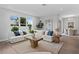 Spacious living room with a large sectional sofa, wooden coffee table, and dining area in background at 4017 W Fig St, Tampa, FL 33609
