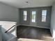 Bright room featuring hardwood floors, a door to the outside, and multiple windows at 4017 W Fig St, Tampa, FL 33609