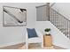 Cozy seating area near staircase, accented with a textured rug and modern wall art at 4017 W Fig St, Tampa, FL 33609