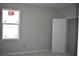 Bright bedroom featuring natural light from the window and a white door at 707 W Fribley St, Tampa, FL 33603