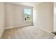 A well-lit bedroom with neutral carpet and a view of lush greenery through the window at 7615 S Swoope St, Tampa, FL 33616