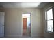 A bedroom featuring neutral walls, carpet, a window, and a walk-in closet at 7615 S Swoope St, Tampa, FL 33616