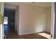 Bright hallway featuring hardwood floors, fresh paint and a white interior door at 7615 S Swoope St, Tampa, FL 33616