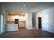 Open-concept living space with a kitchen, staircase, and door leading to other rooms in the home at 7615 S Swoope St, Tampa, FL 33616