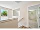 Stairwell landing with wood-look floors featuring a window with a tree view at 7615 S Swoope St, Tampa, FL 33616