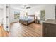 Main bedroom with wood-look floors and ensuite bathroom access at 19029 Us Highway 19 N # 4-5, Clearwater, FL 33764