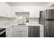 Modern kitchen with white cabinets and quartz countertops at 19029 Us Highway 19 N # 4-5, Clearwater, FL 33764