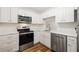 Modern white kitchen with stainless steel appliances at 19029 Us Highway 19 N # 4-5, Clearwater, FL 33764