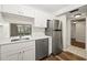 Updated kitchen features white cabinets, stainless steel appliances, and quartz countertops at 19029 Us Highway 19 N # 4-5, Clearwater, FL 33764