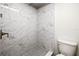 Updated shower with marble-look tile and hexagon floor tile at 19029 Us Highway 19 N # 4-5, Clearwater, FL 33764