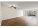 Bright living room with wood-look floors and sliding glass doors to balcony at 19029 Us Highway 19 N # 4-5, Clearwater, FL 33764