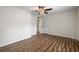 Bedroom with wood-look floors and door to hallway at 19029 Us Highway 19 N # 4-5, Clearwater, FL 33764
