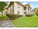 Building exterior showcasing landscaping and a grassy area at 19029 Us Highway 19 N # 4-5, Clearwater, FL 33764