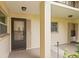 Condo building entry with dark brown door and screen at 19029 Us Highway 19 N # 4-5, Clearwater, FL 33764