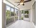 Bright lanai with tile floors, sliding glass doors, and ceiling fan at 19029 Us Highway 19 N # 4-5, Clearwater, FL 33764