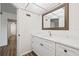 Bathroom with white vanity, quartz countertop and a view into another room at 19029 Us Highway 19 N # 4-5, Clearwater, FL 33764