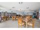 Community room with tables, chairs, and bookcases at 19029 Us Highway 19 N # 4-5, Clearwater, FL 33764