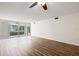 Living room with wood-look floors and access to a private balcony at 19029 Us Highway 19 N # 4-5, Clearwater, FL 33764