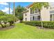 Side view of building with lush green landscaping at 19029 Us Highway 19 N # 4-5, Clearwater, FL 33764