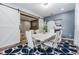 Elegant dining room with white table and chairs, barn doors at 11116 Hoffner Edge Dr, Riverview, FL 33579