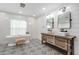 Elegant bathroom with a freestanding tub, double vanity, and patterned floor at 11116 Hoffner Edge Dr, Riverview, FL 33579