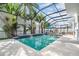 Inviting screened pool area with lounge chairs and outdoor seating at 11116 Hoffner Edge Dr, Riverview, FL 33579