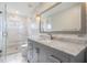 Modern bathroom with gray vanity, marble countertops, and a glass shower at 11116 Hoffner Edge Dr, Riverview, FL 33579