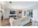 Spacious living room with large sectional sofa and access to the pool at 11116 Hoffner Edge Dr, Riverview, FL 33579
