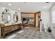 Elegant bathroom with double vanity, patterned flooring, and a view to the bedroom at 11116 Hoffner Edge Dr, Riverview, FL 33579