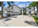 Two-story home with a three-car garage and palm trees at 11116 Hoffner Edge Dr, Riverview, FL 33579
