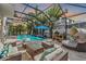Inviting pool area with covered patio, lounge furniture, and a waterfall feature at 11116 Hoffner Edge Dr, Riverview, FL 33579