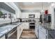 Bright kitchen with white cabinets, granite countertops, and stainless steel appliances at 11116 Hoffner Edge Dr, Riverview, FL 33579