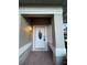 White front door entry with tile flooring and light fixture at 12034 Stone Crossing Cir, Tampa, FL 33635