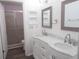 Bathroom featuring double sink vanity with marble top and a glass door shower at 1306 Idlewood Dr # 53, Sun City Center, FL 33573