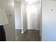 Bright hallway featuring a white front door and durable gray wood-look flooring at 1306 Idlewood Dr # 53, Sun City Center, FL 33573