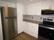 Modern kitchen with stainless steel appliances, granite countertops, and white cabinets at 1306 Idlewood Dr # 53, Sun City Center, FL 33573