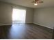 Bright living room with modern ceiling fan and sliding glass door to the outside area at 1306 Idlewood Dr # 53, Sun City Center, FL 33573