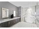 Modern bathroom featuring double vanity, marble accents, soaking tub, and glass shower at 2912 W Santiago St # 1703, Tampa, FL 33629