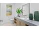 Simple bathroom with a single sink, marble countertop, and light wood cabinets at 2912 W Santiago St # 1703, Tampa, FL 33629