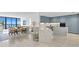 Modern kitchen with light blue cabinets and marble island, open to dining area at 2912 W Santiago St # 1703, Tampa, FL 33629