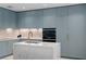 Modern kitchen with light blue cabinets and marble island at 2912 W Santiago St # 1703, Tampa, FL 33629
