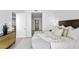 Spacious bedroom with large bed, stylish decor, and access to a balcony with water views at 2912 W Santiago St # 1703, Tampa, FL 33629