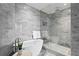 Modern bathroom with a glass shower and soaking tub at 2912 W Santiago St # 903, Tampa, FL 33629