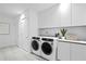 Modern laundry room with side-by-side washer and dryer at 2912 W Santiago St # 903, Tampa, FL 33629