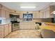 Efficient kitchen with stainless steel appliances and light wood cabinets at 7131 El Dewitt St, Zephyrhills, FL 33541