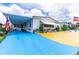 Mobile home exterior with carport and colorful landscaping at 7131 El Dewitt St, Zephyrhills, FL 33541